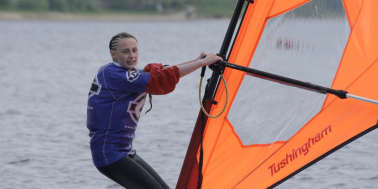 Woman windsurfing at Debdale Outdoor Centre in Gorton