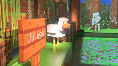 A life-sized Minecraft exhibit showing a blocky chicken and an orange sign labeled "village" with a pixelated skeleton projected in the background. The immersive environment mimics the game’s signature forest biome.