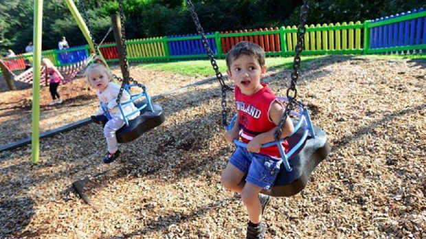 Kids on swings at Roker Park in Sunderland