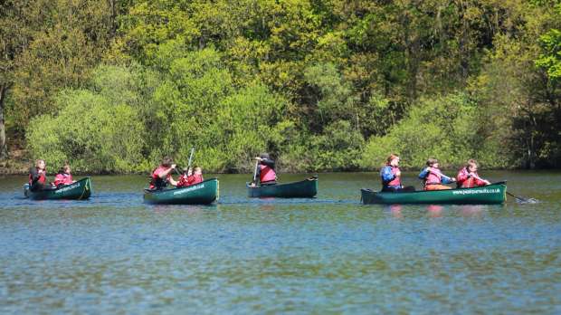 People rowing canoes at Underbank Activity Centre in Sheffield