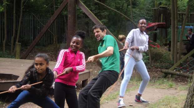 People playing tug of war at Goldhill Adventure Playground in Leicester