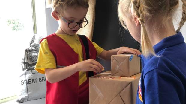 Two kids playing in the post office at Play Avenue 