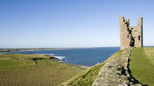 Ruins of Dunstanburgh Castle by sea in Alnwick