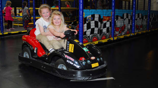 Girls on dodgem cars at Rascals Party and Play Centre in Preston