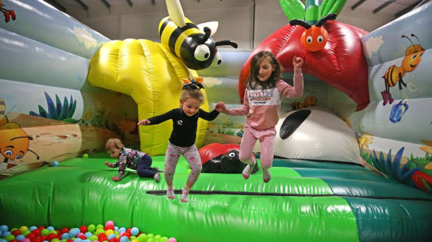 Little girls jumping in the ball pit
