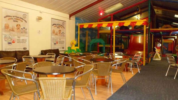 Indoor soft play frame and seating area at Barnabys Playbarn in Northwich