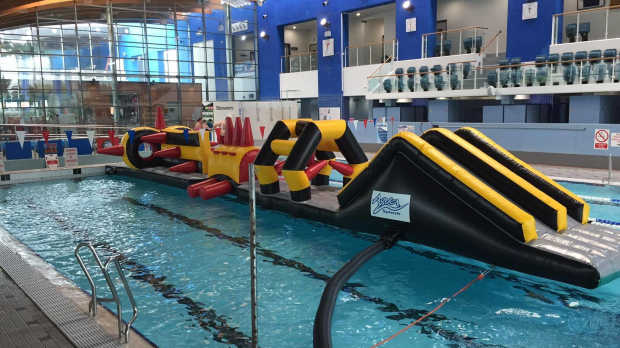 Inflatable obstacle course on swimming pool at AquaSplash in Jersey