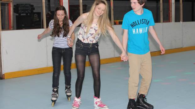 Teenagers roller blading at The Wigwam Roller Rink in Bangor