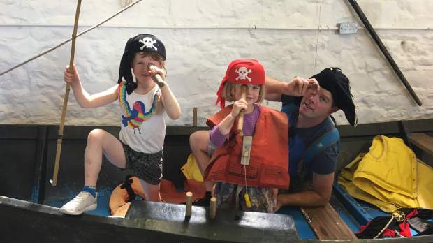 Kids dressed as pirates on boat at Watchet Boat Museum in Somerset
