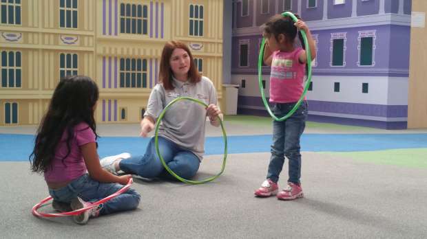 Girls hula hooping at Under 1 Roof Kids in London