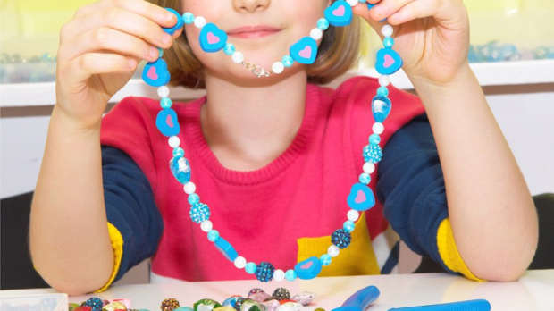Girl making beaded necklace at Cafe Craft in Bearwood