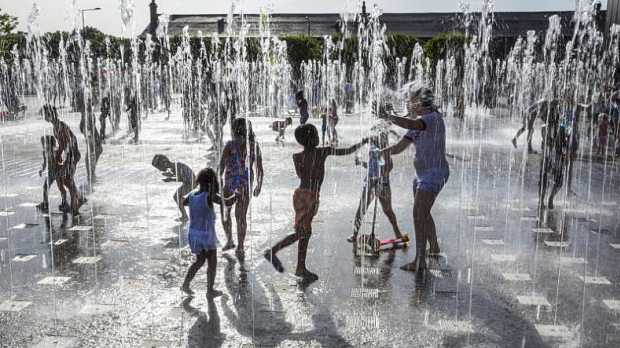 Kids in sprinklers at Granary Square Water Feature in Kings Cross