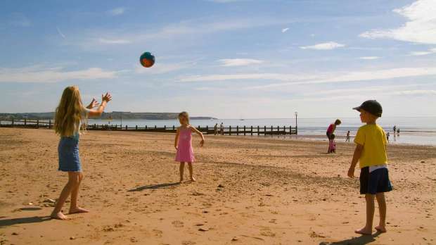 Kids playing catch at Dawlish Warren Beach