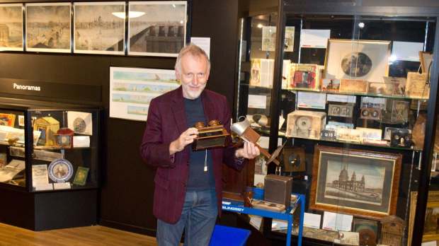 Man holding antiques at Bill Douglas Centre - History of Cinema in Exeter