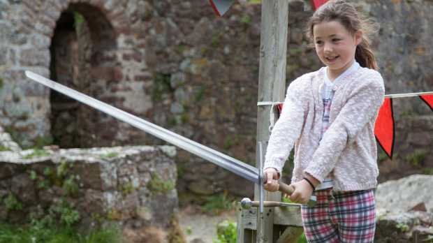 Girl holding sword at Mont Orgueil Castle in Jersey