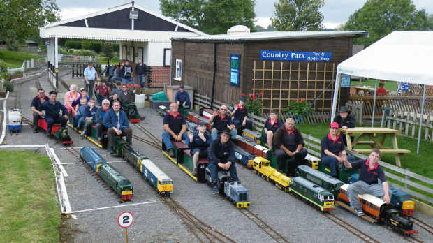 People on miniature trains at Strawberry Line Miniature Railway in Bristol