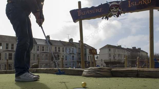 Boy playing golf at West Hoe Park in Plymouth