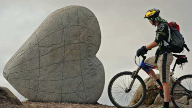 Mountain biker at Heart-Cleft Stane at 7stanes Dalbeattie