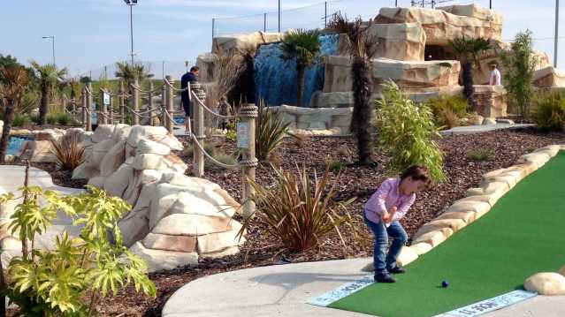 Kid playing mini golf at Golf Kingdom in Chadwell Heath