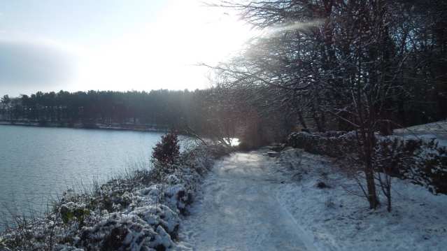 Walking path next to lake at Ogden Water Country Park in Halifax