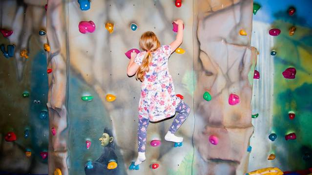 Girl climbing at The Moors National Park Centre in Whitby
