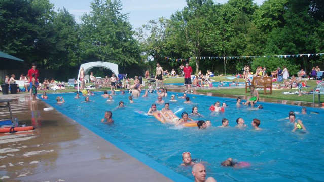 Families swimming at Askham Outdoor Swimming Pools in Penrith