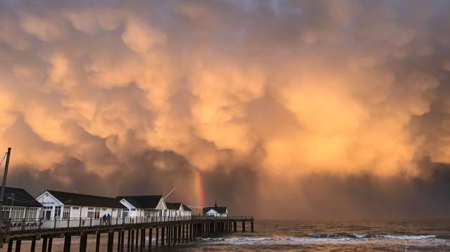 Sun shining through clouds at Southwold Pier 