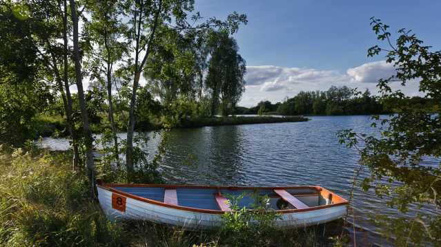 Boat in lake at Cotswold Water Park in Cirencester