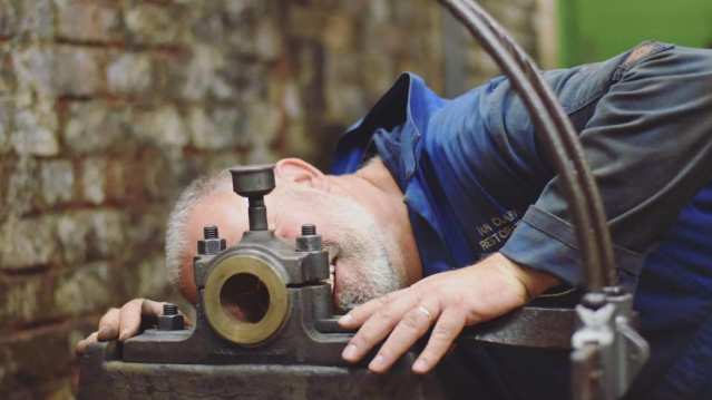 Man working machine at Newman Brothers Coffin Works in Birmingham