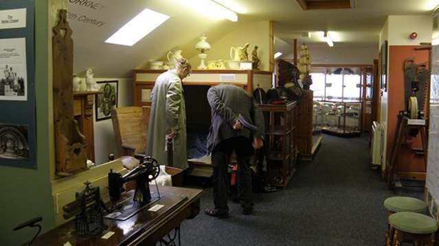 Visitors exploring displays at Fossil and Heritage Centre in The Orkney Isles