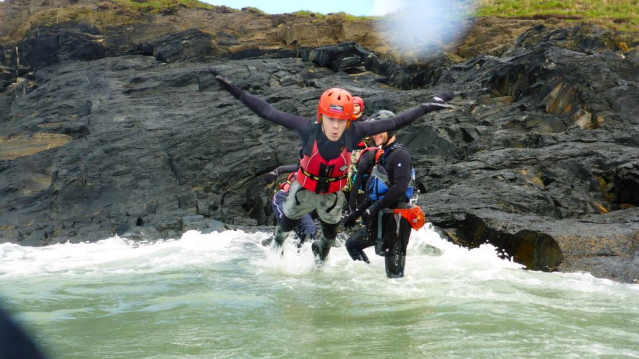 People jumping in water at Celtic Quest Coasteering in Haverfordwest
