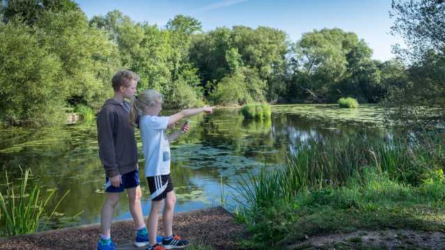 Kids by pond at Kingsbury Water Park in Sutton Coldfield