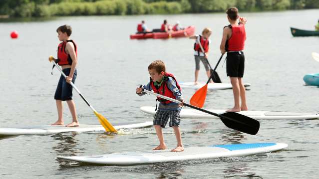 Boys on paddleboard at Dinton Pastures Country Park in Wokingham