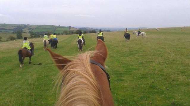 People horse riding at Long Mountain Pony Trekking Centre in Shrewsbury