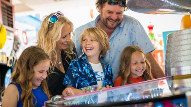 Family in arcade at Harbour Park in Littlehampton