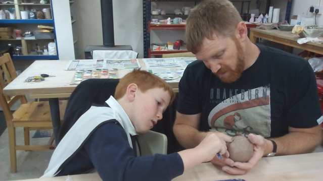 Dad and son making craft at Eastcott Studios in Swindon