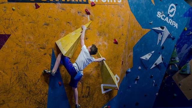 Boy bouldering at The Climbing Academy Boulder Club Glasgow