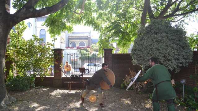 Men dressed as knights sword fighting at Worthing Museum and Art Gallery