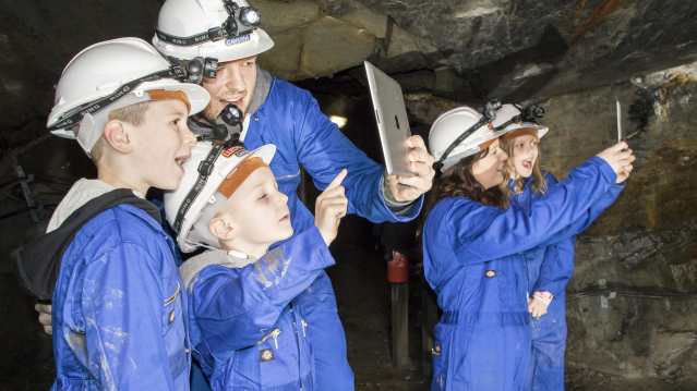 People with ipads at The Slate Caverns in Blaenau Ffestiniog