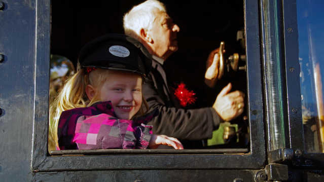 Girl by train conductor at Strathspey Railway in Aviemore