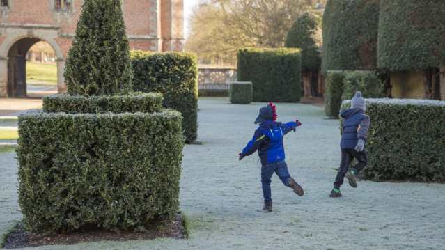 Kids playing in the garden at Charlecote Park in Warwickshire