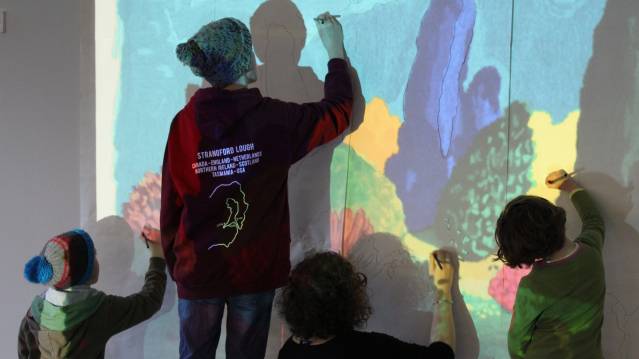 People drawing on wall at Dovecot Studios in Edinburgh