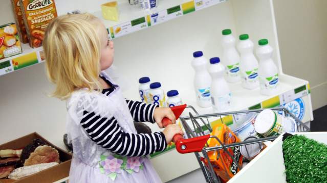 Girl role play shopping at Tots Town in Norwich