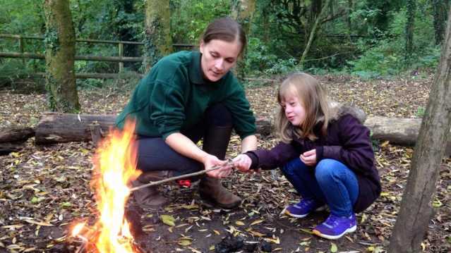 People building fire at Greenmeadow Community Farm in Cwmbran