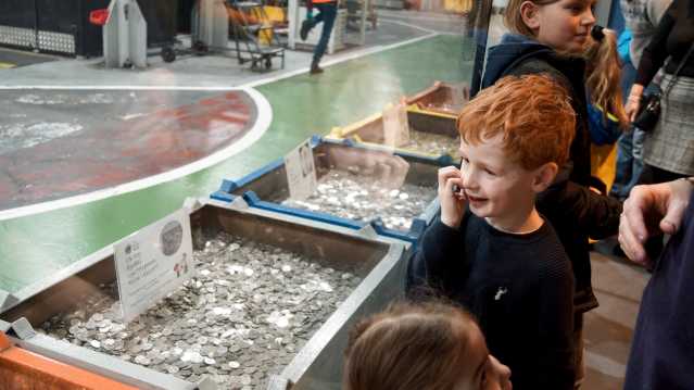 A little boy looking at the exhibitions at The Royal Mint Experience