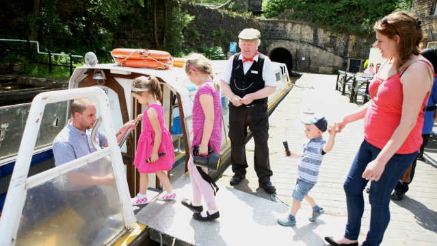Family getting on canal boat at Standedge Tunnel and Visitor Centre in Marsden