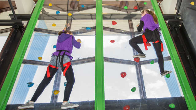 Girls climbing at Clip n Climb in Stratford upon Avon
