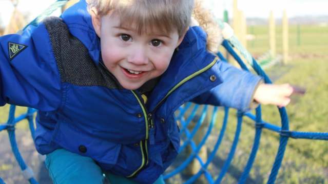 Boy on adventure playground at Warren Farm Holiday Centre in Burnham on Sea