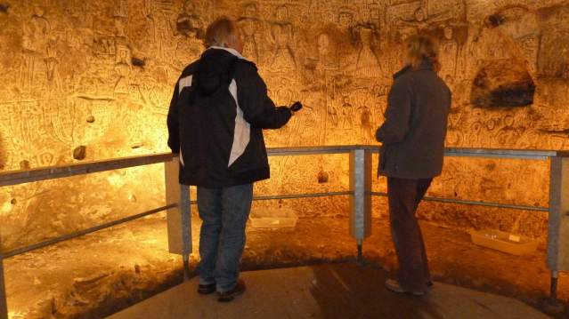 People looking at cave carvings at Royston Cave