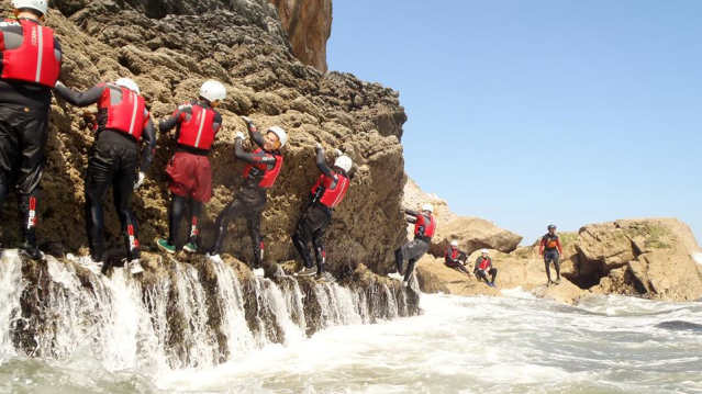People climbing rocks at Reach Outdoors in Paignton